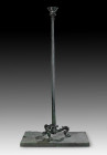 Roman bronze candelabrum with tripod foot with lion's legs. The shaft is fluted and terminates in a crater-shaped top with inlaid palmette decor. 1st ...