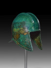 Illyrian bronze helmet. Greek, 7th - 5th century BC. H 26cm. Two double ridges on the round calotte for the crest, which was attached to holes at the ...