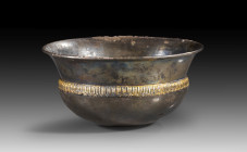 Silver phiale with gold-plated tongue bar band. Greece, 5th century BC. H 7.1cm, ø top 14cm. Offering bowl with hemispherical body with central omphal...