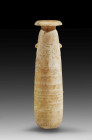 Alabastron. Elongated ointment vessel made of alabaster in drop shape with side knobs under each of which there are raised triangles. Eastern mediterr...