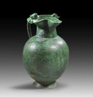 Bronze oinochoe with treefoil spout. Etruscan, 5th century BC. H 24,5cm. Handle with lower applique in form of a palmette with incised details. With c...