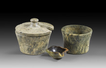 Small collection of Minoan stone vessels. EM III - MM I, 2200 - 1800 BC. a) Pyxis with lid made of serpentine. H with lid 5.3cm, ø 6.1cm. Small defect...