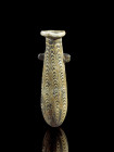 Core-formed alabastron. Eastern Mediterranean, 4th - 2nd century BC. H 11.5cm. Dark blue and white glass. Teardrop-shaped cosmetic vessel with plate-s...