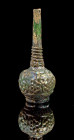 Mold-shaped bottle. Islamic, 11th - 12th century. H 18,3cm. Green translucent glass. Globular body on thick ring foot, with tall cylindrical neck and ...