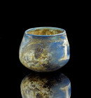 Blue and white marbled vessel. Roman, 1st century AD. H 5,5cm. With round body. Iridescence, sinter, reassembled from fragments. Blau und weiß marmori...