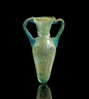 Amphoriskos. Eastern Mediterranean, 4th - 5th c. AD. H 13cm. Green and blue translucent glass. Conical body with handles, rounded shoulder, slim neck ...