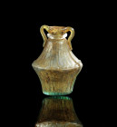 Roman biconical amphoriskos of colorless glass with fine ornament. About 1st century AD. Tiny fissure in the neck, otherwise intact. Seltener bikonisc...