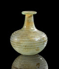 Unguentarium with bulbous body and white trail decoration. H 6,4cm. Eastern mediterranean, 1st century AD. Translucent glass. Light iridescence, intac...