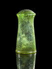 Franconian Sturzbecher. H 11,5cm. Franconian, 2nd half 6th century AD. Green clear glass with a concave wall with very fine vertical ribs and a convex...