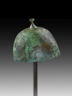 Northern Europe Ha B1, 1000 BC. H 17.3cm. Bronze bell helmet with separately cast crown pommel, a square plate riveted on as a lower bearing. Traces o...