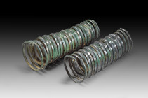 Pair of large and impressive forearm spirals made of a band with a central ridge and geometrical decor. Central Europe, Bronze Age, about 12th - 10th ...