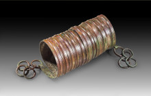 Bronze armlet made of band with hatched decoration, H 15cm. Hallstatt Period, about 800 BC. Browngreen patina, intact. Armspirale aus Bronze. Hallstat...