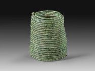 Bronze spiral armlet. Bronze Age, about 1500 BC. Green patina, one miniature spiral at the ending broken. Spiralarmreif aus Bronze. Bronzezeit, ca. 15...