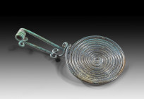 Celtic spiral fibula. Hallstatt, 12th - 11th century BC. L 13.5cm, ø 6.8cm. Bronze. With movable needle on a transverse spiral mount and foot with two...