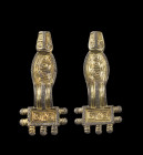A pair of migration period fibulae with rectangular and oval foot. Silver, partially gilded. About 6th century AD. One piece broken and reassembled. T...
