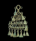 Hanger. L 20cm. Bronze. Black Sea Area, 1st millenium BC. Triangular shape with a large eyelet at the top and several eyelets at the edge, some of whi...