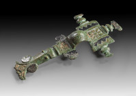 Bronze long brooch, the rectangular head-plate with three stylised bird's head, remains of gilding and zig-zag-decor in niello, with arched bow, the f...