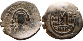 Maurice Tiberius (582-602) Follis. Obverse: Helmeted and cuirassed bust facing, holding globus cruciger and shield., Reverse: Large M above cross, ANN...