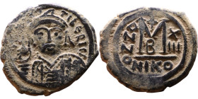 Maurice Tiberius (582-602) Follis. Obverse: Helmeted and cuirassed bust facing, holding globus cruciger and shield., Reverse: Large M above cross, ANN...