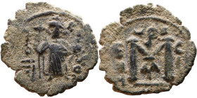 al-Malik ibn Marwan (687-705), Byzantine style folis Obverse: Imperial figure holding globe and cross Reverse: M and inscription

22mm 3,25g