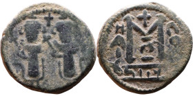 al-Malik ibn Marwan (687-705), Byzantine style folis Obverse: Two standing figures Reverse: Large M and inscription

19mm 4,11g