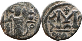 al-Malik ibn Marwan (687-705), Byzantine style folis Obverse: Imperial figure holding globe and cross Reverse: M and inscription

17mm 2,94g