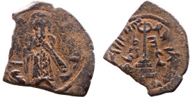 al-Malik ibn Marwan (687-705) Follis. Obverse: Standing caliph Reverse: Modified cross potent set on steps

20mm 2,47g