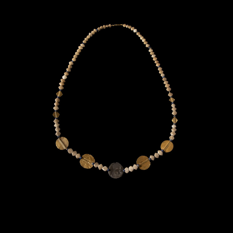 A Sumerian necklace wIth flat gold and silver round beads with white limestone b...