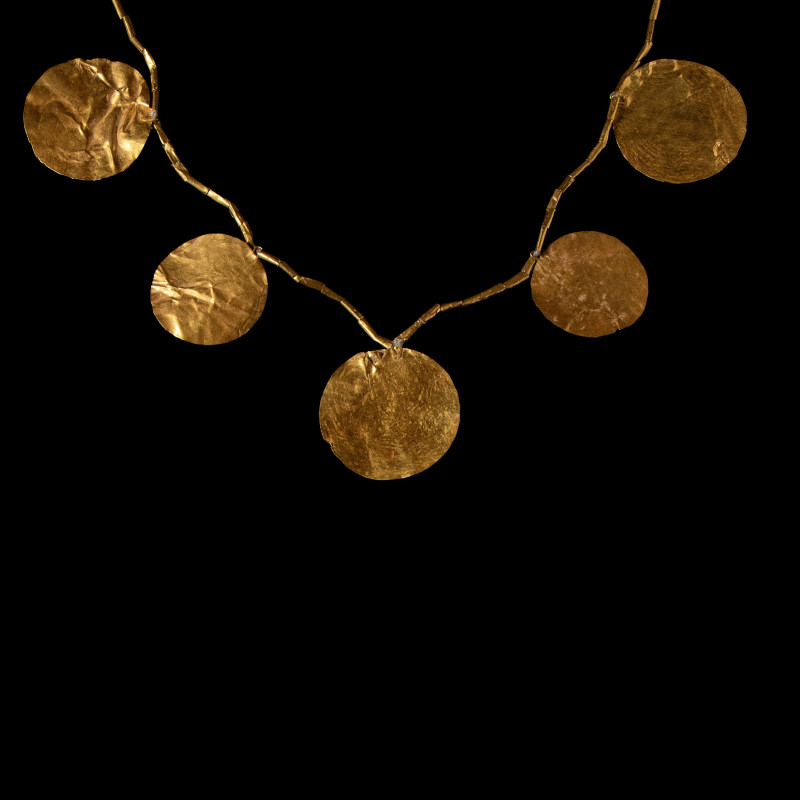 A Sumerian necklace with gold disc and cylindrical beads.
Ca. 2600-2500 BCE.
L...