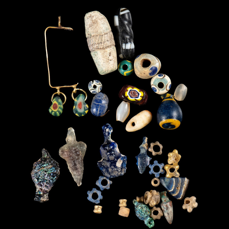 A GROUP OF 31 EGYPTIAN VARIA GLASS, FAIENCE BEADS AND AMULETS.
New-Kingdom to R...