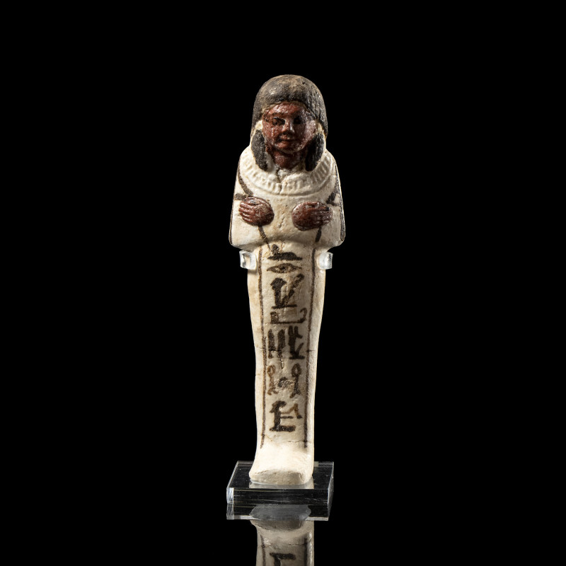 AN EGYPTIAN WHITE FAIENCE GLAZED SHABTI OF SETHINEHEH.
New-Kingdom, Reign of Ra...