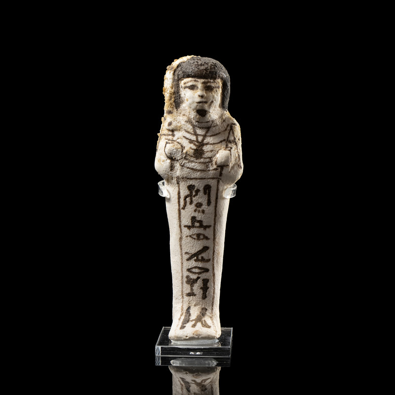 AN EGYPTIAN WHITE FAIENCE GLAZED SHABTI FOR THE ROYAL SEM-PRIEST HORI.
New-King...
