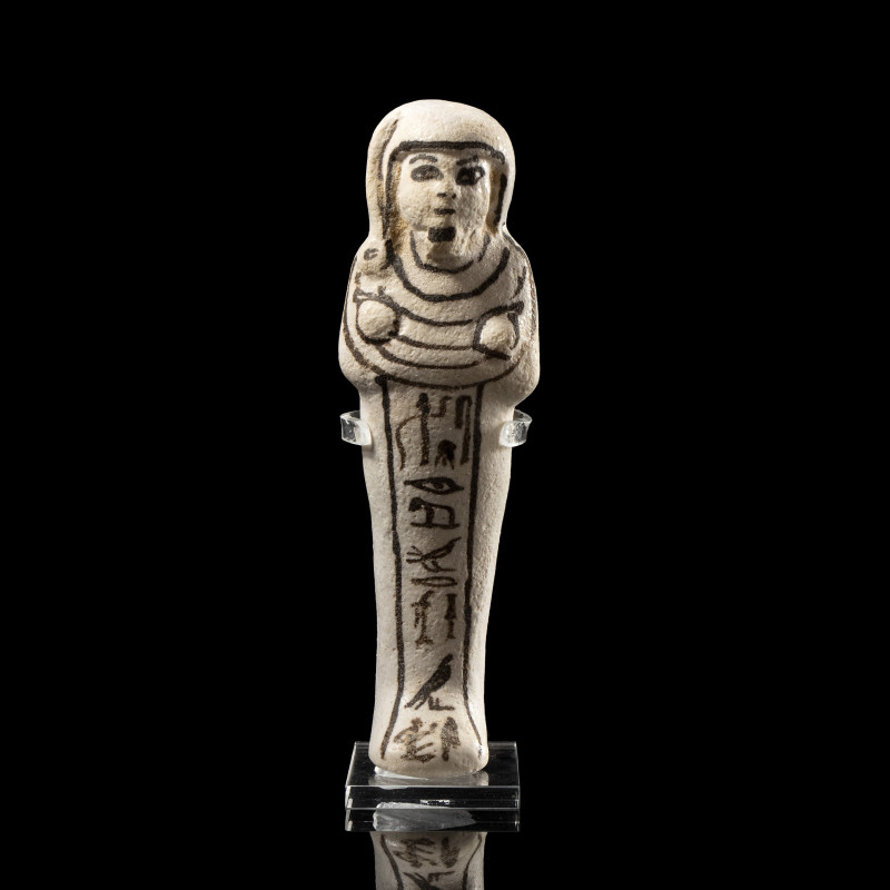 AN EGYPTIAN WHITE FAIENCE GLAZED SHABTI FOR THE ROYAL SEM-PRIEST HORI.
New-King...