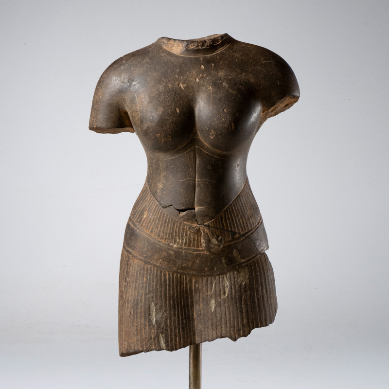 A KHMER GREY SANDSTONE FIGURE FIGURE OF A FEMALE DEITY. Baphuon style, 11th cent...