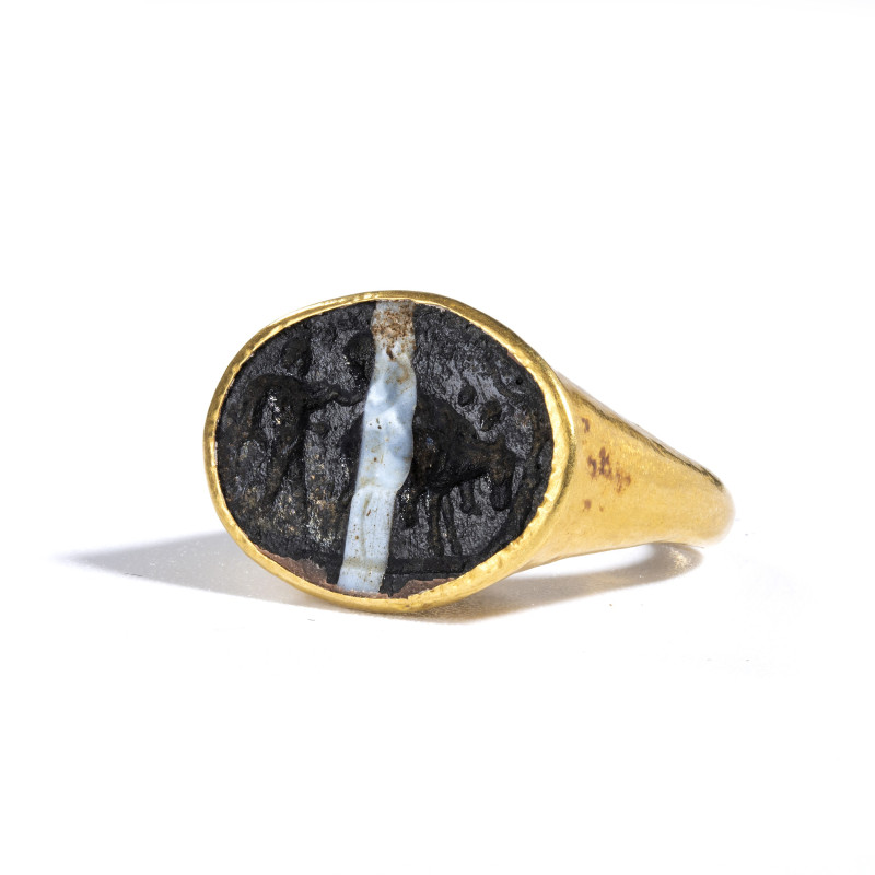 *A ROMAN GOLD RING SET WITH A GLASS INTAGLIO.
1st century A.D.
Diam. 1,8 cm
...