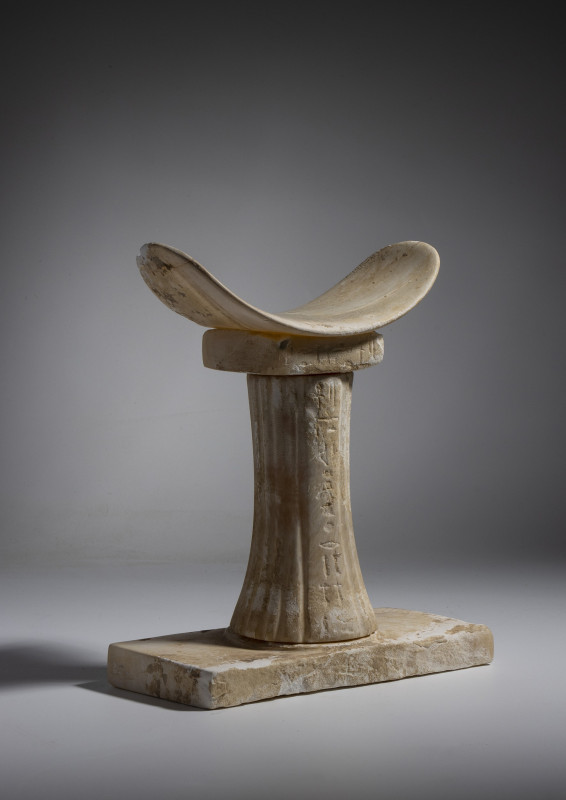 *AN EGYPTIAN ALABASTER HEAD REST OF NEFER-NEFEROU.
Old Kingdom, Dynasty 6, 2400...