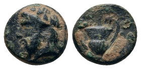 Cyclades. Naxos circa 400 BC. Bronze Æ . Wreathed and bearded head of Dionysos left / Kantharos. two leaves hanging from handles; grape bunch above.
...