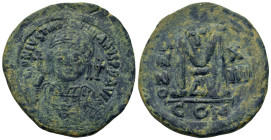 Justinian I (527-565). Æ Follis (37.7mm,23g). Helmeted and cuirassed facing bust, holding globus cruciger and shield, cross r. in field. R/ ANNO - X /...
