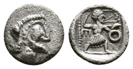 UNCERTAIN LEVANTINE. (4th century BC).
AR Tetartemorion
Obv: Head of Silenos (?) to right.
Rev: Slinger in throwing stance left, monoskeles to left, l...