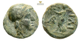 Troas, Ilion AE Circa 301-281 BC. (0.54g, 7.8mm) Helmeted head of Athena to right / Archaic cult statue of Athena Ilias to left, holding filleted dist...