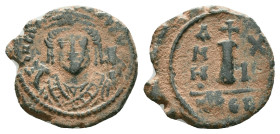 JUSTINIAN I.527-565 AD.Antioch mint.AE Decanummium. DN IVSTINIANVS PP AVG, helmeted, cuirassed bust facing, holding cross on globe and long sceptre, c...