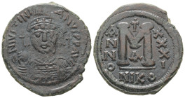 Justinian I, AD 527-565. AE, Follis. 16.27 g. 32.53 mm. Nicomedia.
Obv: DNIVSTINI-ANVS PPAVC. Frontal bust of Justinian I wearing helmet with plume, d...