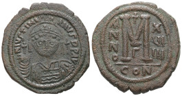 Justinian I, AD 527-565. AE, Follis. 20.05 g. 36.28 mm. Constantinople.
Obv: DNIVSTINI-ANVS PPAVC. Frontal bust of Justinian I wearing helmet with plu...