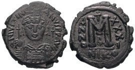 Justinian I, AD 527-565. AE, Follis. 15.51 g. 32.25 mm. Nicomedia.
Obv: DNIVSTINI-ANVS PPAVC. Frontal bust of Justinian I wearing helmet with plume, d...
