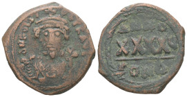 Phocas, AD.602-610. AE, Follis. 10.48 g. 29.16 mm. Constantinople.
Obv: D N FOCAS PЄRP AVG. Crowned bust facing, wearing consular robes and holding ma...