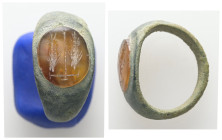 Greco-Roman bronze finger ring with intaglio (1st–3rd century AD)
Bronze finger ring set with an oval intaglio, likely carnelian, engraved with two ea...