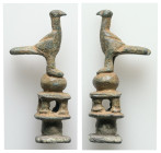 Roman Bronze Eagle on Monument Statuette (AD 1st-2nd centuries).
A bronze figure of an eagle on a plinth stand.
Weight: 27.52 g. 
Diameter: 54.67 mm.