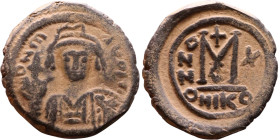 Maurice Tiberius (582-602) Follis. Obverse: Helmeted and cuirassed bust facing, holding globus cruciger and shield., Reverse: Large M above cross, ANN...