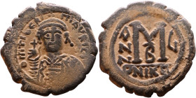 Maurice Tiberius (582-602) Follis. Obverse: Helmeted and cuirassed bust facing, holding globus cruciger and shield., Reverse: Large M above cross, ANN...