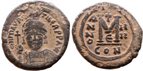 Maurice Tiberius (582-602) Follis. Obverse: Helmeted and cuirassed bust facing, holding globus cruciger and shield., Reverse: Large M above cross, ANN...